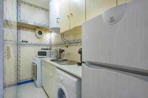 a small kitchen with a sink and a refrigerator at Romantic Apartment + Tejo River View in Lisbon
