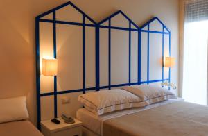 A bed or beds in a room at Mini Hotel