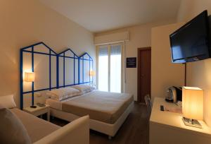 A bed or beds in a room at Mini Hotel