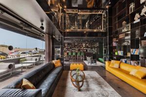 a living room filled with lots of furniture at Alexander Hotel in Tel Aviv