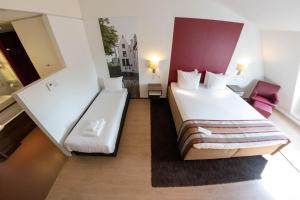 Postel nebo postele na pokoji v ubytování City Hotel Gouda, WorldHotels Crafted Collection