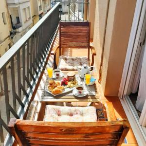 un tavolo per la colazione con vassoio di cibo su un balcone di Gallimó Apartaments a L'Ampolla