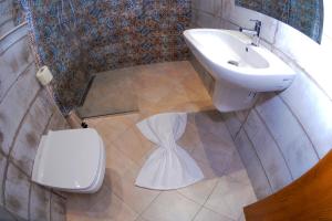 a bathroom with a sink and a toilet at DAR AMMAR in El Jem