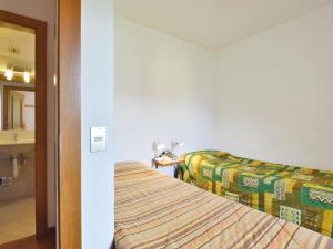 a hotel room with a bed and a mirror at Apartment Cesa Palua by Interhome in Alba di Canazei +14 photos