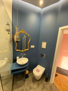 a bathroom with a sink and a toilet at Apartamenty Royal Point Bed & Bath in Szczecin