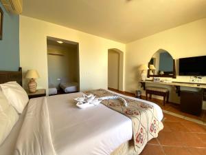 a hotel room with a bed and a sink at ONATTI Beach Resort - Marsa Alam in Quseir