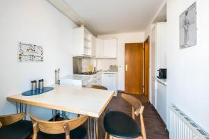 a kitchen with a wooden table and chairs at Haus Roland in Helgoland