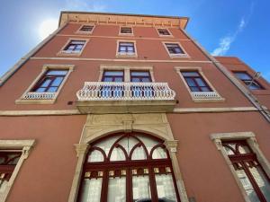 a tall building with a balcony on top of it at Porto.Leça - Studios and Apts (Apt E) in Leça da Palmeira