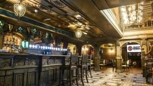 a bar in a room with chairs and a ceiling at Skeffington Arms Hotel in Galway