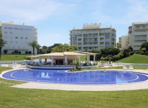 
a large swimming pool in front of a large building at Vila Marachique Mariosilvat in Alvor
