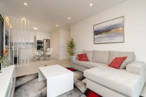 a living room with a couch and a table at CASA GEORGINA in Calheta