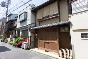 a building with two garage doors on a street at Rikyu-an Machiya House in Kyoto