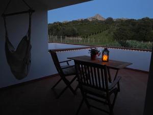 a table and two chairs with a candle on a balcony at Agriturismo Lu Branu in Arzachena