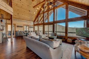 a living room with couches and large windows at The Nest in Blue Ridge