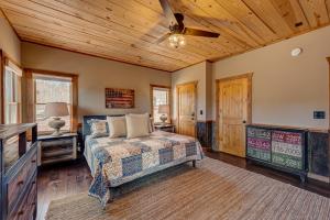 a bedroom with a bed and a ceiling fan at The Nest in Blue Ridge