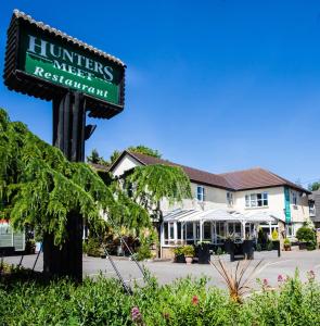a sign for a hotel in front of a building at Hunters Meet in Bishops Stortford