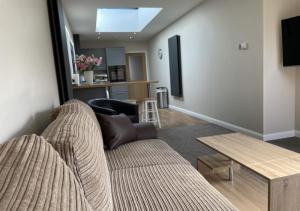 a living room with a couch and a table at The Annexe - Pagham in Pagham