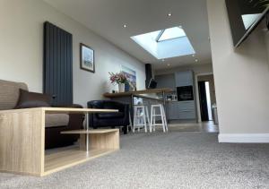 a living room with a couch and a table at The Annexe - Pagham in Pagham