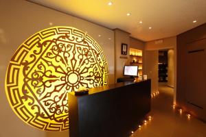 a lobby with a large gold mandala on the wall at Regency Tunis Hotel in Gammarth