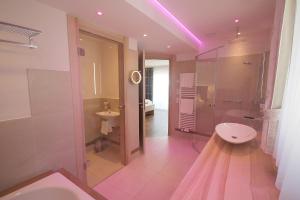 a bathroom with a toilet and a shower and a sink at Genuss- und Wellnesshotel Bercher in Waldshut-Tiengen
