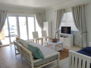 a living room with a bed and a tv at Pearly Bay in Pearly Beach