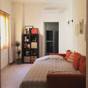 a bedroom with a bed and a book shelf at Casa 28 in Bologna