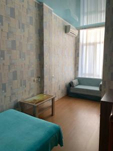 a room with a bed and a couch and a table at Town-house Golden Bugaz in Karolino-Buhaz +6 photos