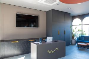 an office with a reception desk and a blue couch at Modica Boutique Hotel in Modica