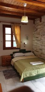 a bedroom with a large bed and a window at EVI Studios & Apartments in Naxos Chora +20 photos
