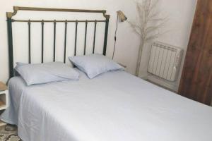 A bed or beds in a room at La musa del Poeta