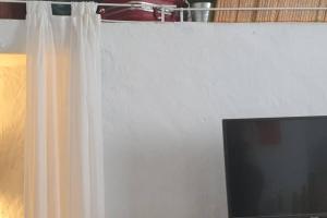 A television and/or entertainment centre at La musa del Poeta