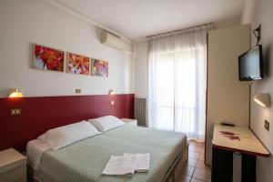 Postel nebo postele na pokoji v ubytování Eco-Hotel Edy