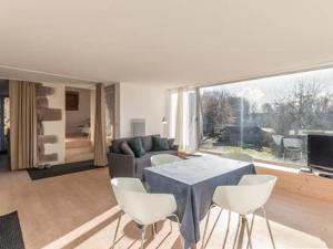 a living room with a blue table and white chairs at Gîte du Mont Gérard in La Lanterne-et-les-Armonts +21 photos