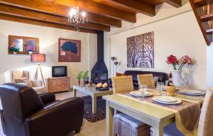 a living room with a table and chairs and a fireplace at Apirathes Residence in Zoúrva