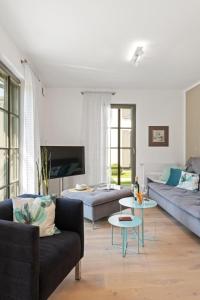 a living room with two couches and a table at Schulstr_ 15 _Sinja_ in Zingst