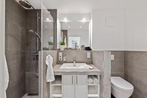 a bathroom with a sink and a toilet and a shower at Schulstr_ 15 _Sinja_ in Zingst +15 photos