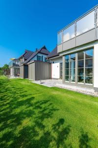 a house with a lawn in front of it at Schulstr_ 15 _Sinja_ in Zingst