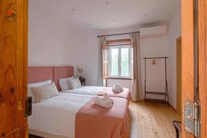 a bedroom with two beds and a window at Quinta da Fortaleza in Elvas +36 photos