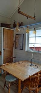 a wooden table and chairs in a room at Sankt Anna Bed and Boat, in Sankt Anna
