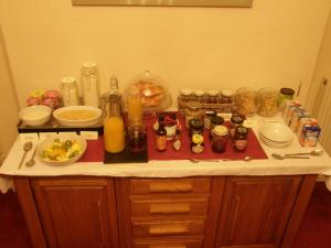 a kitchen counter with food and drinks on it at The Old Vicarage in Llanidloes