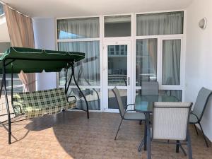 a dining room with a glass table and chairs at Town-house Golden Bugaz in Karolino-Buhaz