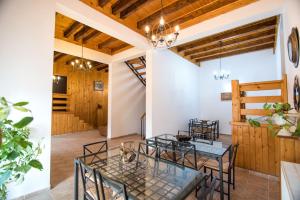 a dining room with a table and chairs and wooden walls at Casa Domneasca in Baia de Fier