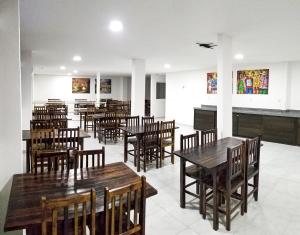 a dining room with wooden tables and chairs at Vila de Maré Hotel in Porto De Galinhas