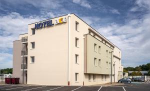 un bâtiment avec un panneau d'hôtel sur son côté dans l'établissement Ace Hotel Annemasse Genève, à Ville-la-Grand