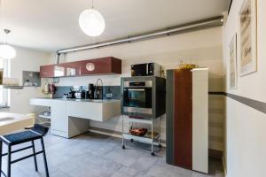 a kitchen with a refrigerator and a counter top at Lago Welcome Clausen II in Luxembourg