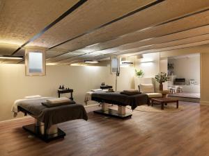a room with three massage beds and a couch at Townhouse Apartments Maastricht in Maastricht