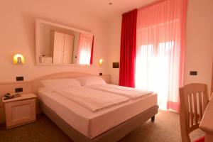 Postel nebo postele na pokoji v ubytování Hotel Virgilio