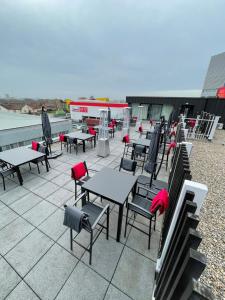 a group of tables and chairs on a patio at Holiday Inn London West, an IHG Hotel in London