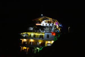 a large building with lights on it at night at Lucky Star View Inn in Bandarawela