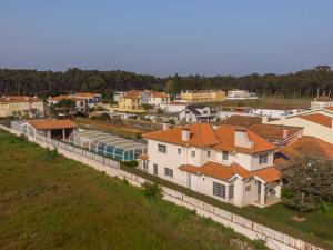 an aerial view of a town with houses and a train at Casa Do Norte in Ovar